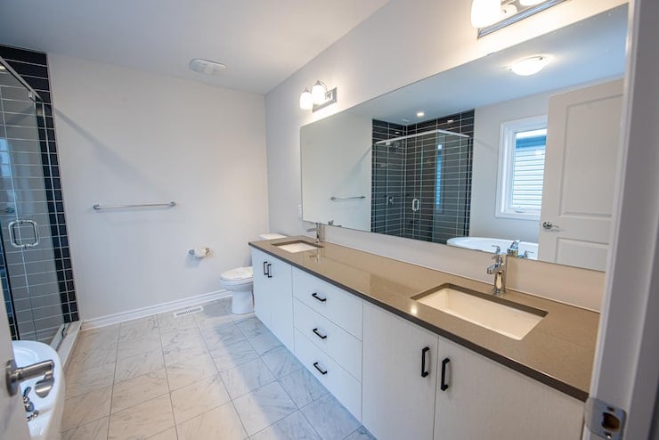 Modern white bathroom vanity with grey countertop used for P2D vanity refinishing